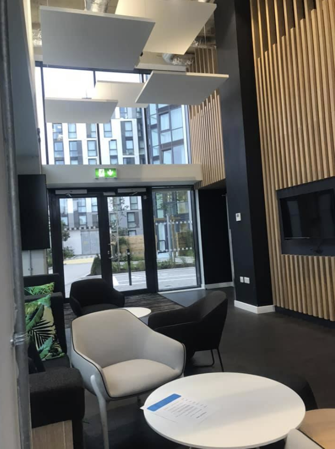 The lobby of the student accommodation with chairs and couches